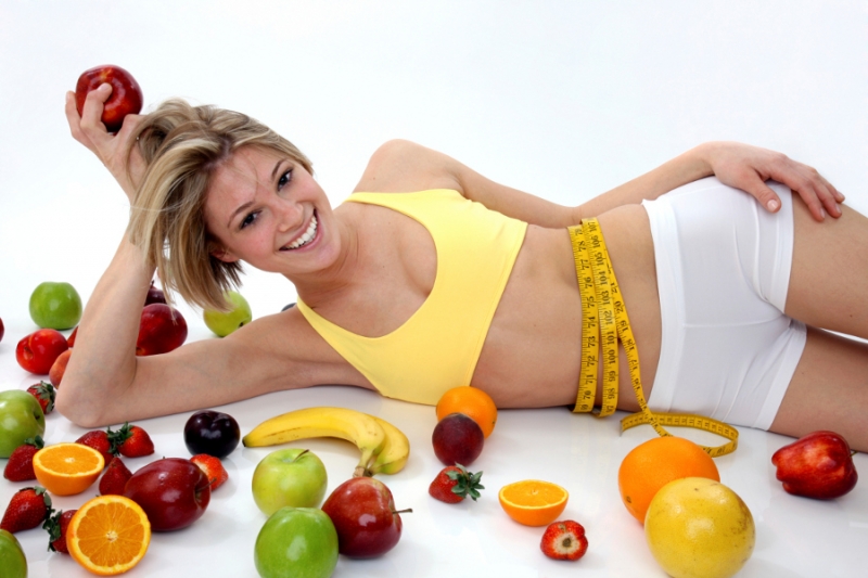 slim woman with many fruits