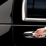 Limo driver opens car door for client